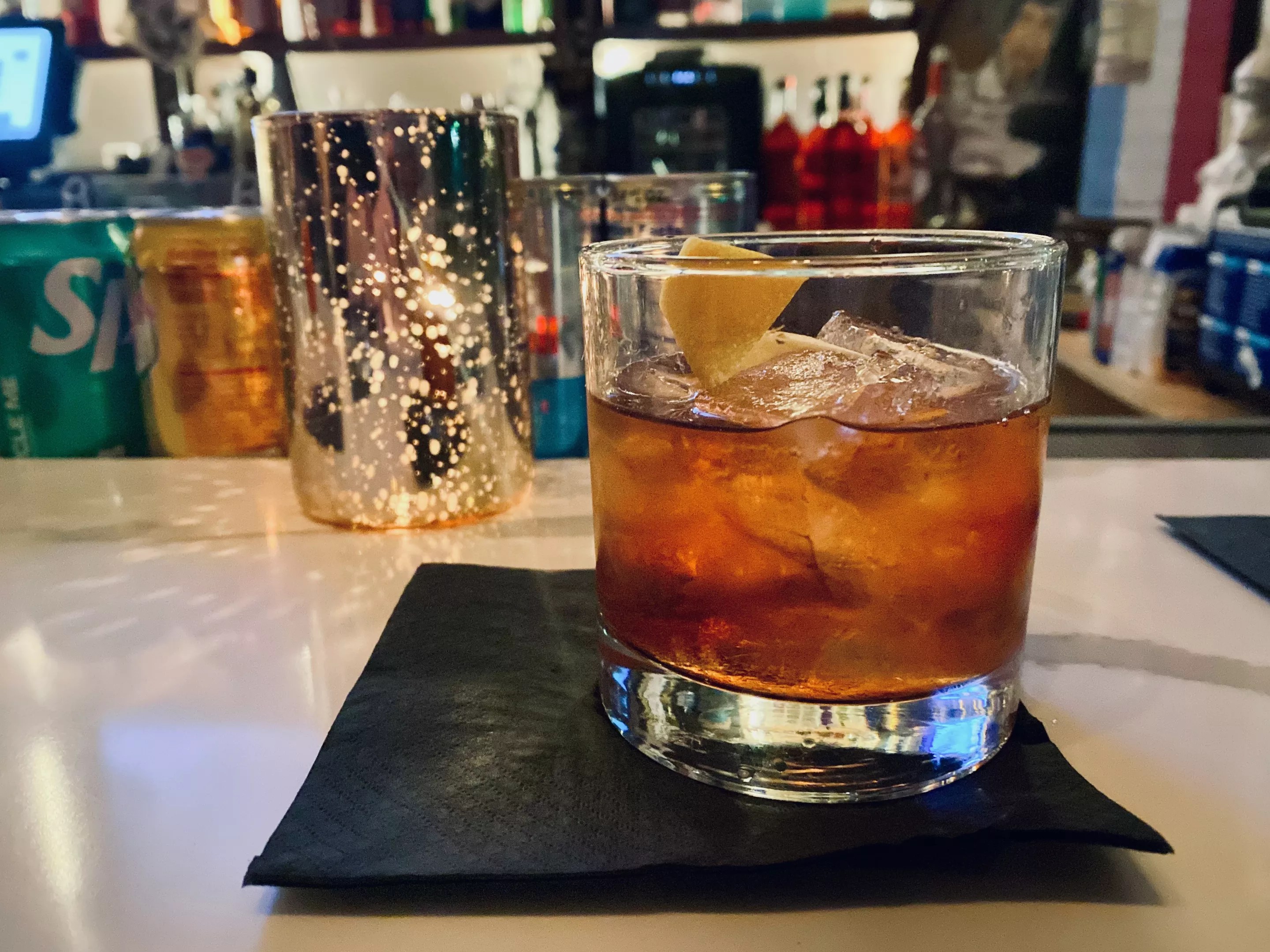 A cocktail on a marble bar.