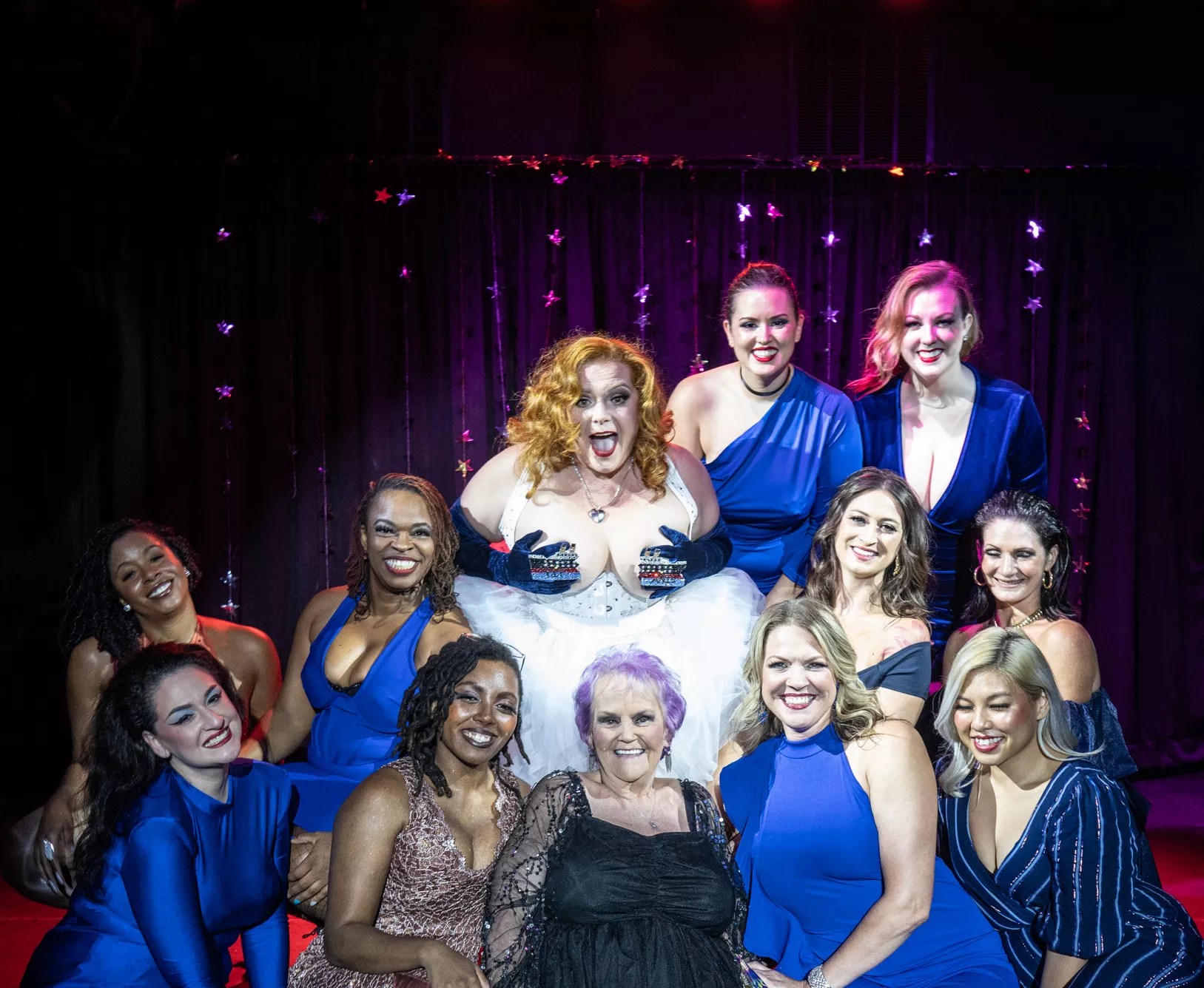 Uptown Review burlesque dancers pose with their newest star: Juicy Jan, making her debut at Dallas' The Nines at age 69.