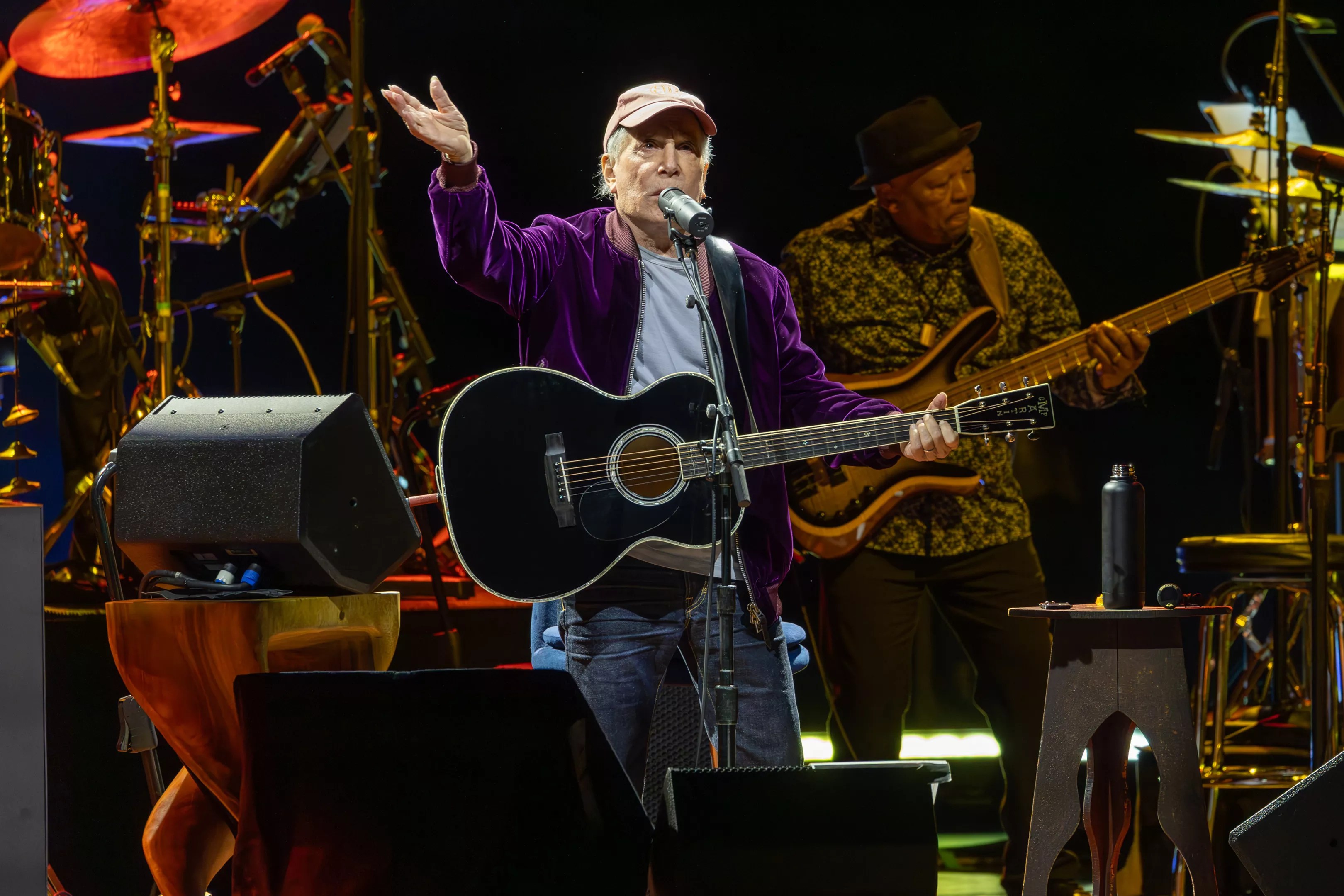 Man performing on stage with a guitar