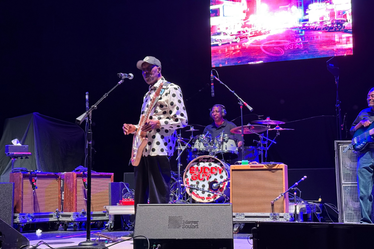 Man performing with guitar on stage