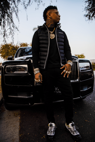 Man posing in front of a car