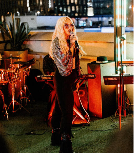 A woman hosting an open mic